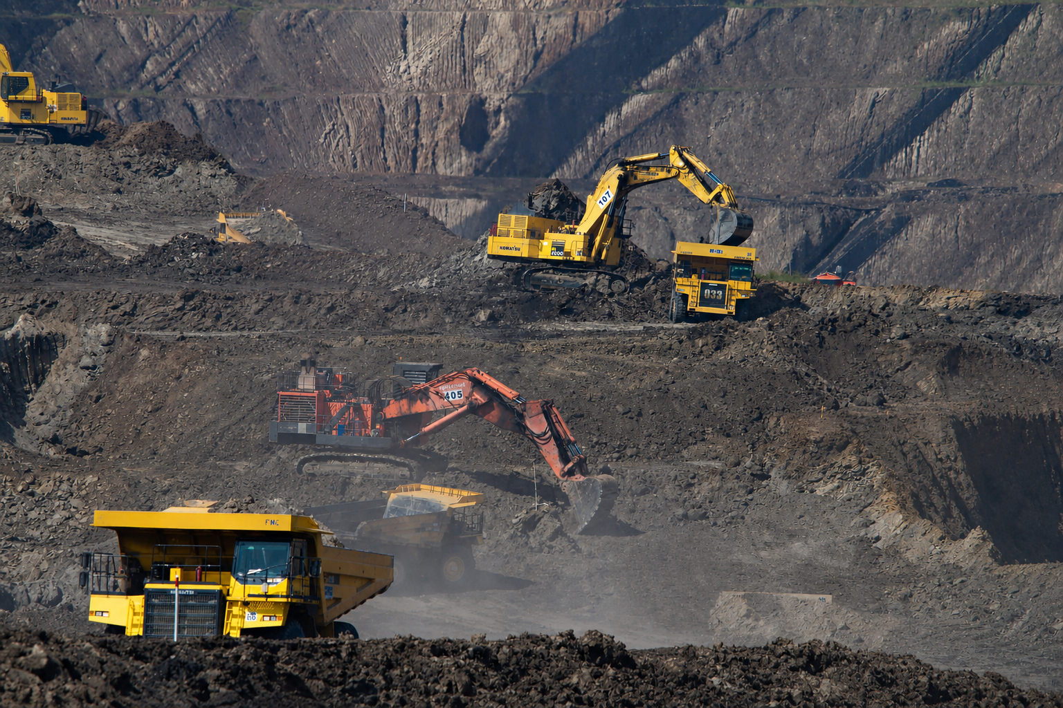 Heavy mining equipment operating in an open-pit mine